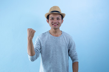 Happy   asian   man   action  on  blue background.