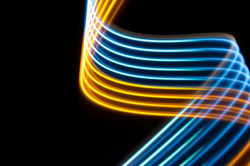 Yellow and blue light curve lines on a black background .