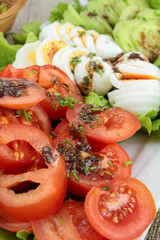 plate of vegetables composed of tomato, cucumber and boiled eggs