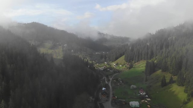 Flight in the clouds in mountains, morning clouds in the mountains aerial, aerial view of morning fog in mountains, Aerial view above the clouds and sky in sunrise time, Majestic clouds in the mountai