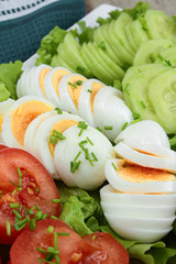 plate of vegetables composed of tomato, cucumber and boiled eggs