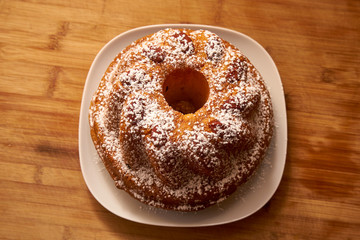 Kugelhopf Cake Powered With Icing Sugar On A Wooden Board