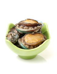 Raw abalones on the white background 