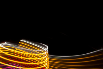 Yellow and pink light curve lines on a black background .