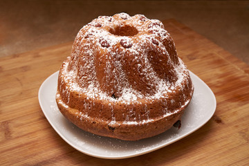 Kugelhopf Cake Powered With Icing Sugar On A Wooden Board