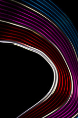 Red, magenta and blue  light curve lines on a black background .