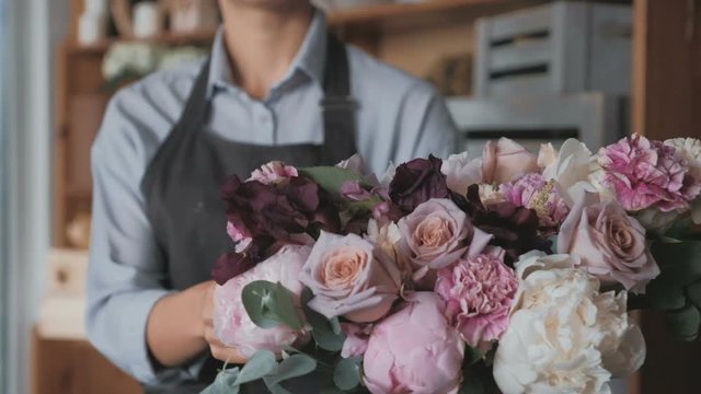 Florist making fresh flower bouquet in flower shop