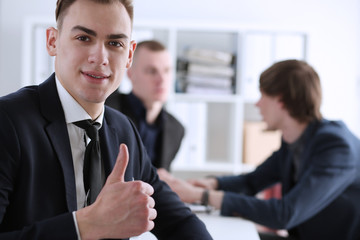 Fototapeta premium Male hand showing OK or approval sign with thumb up