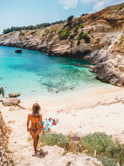 Alone woman exploring beach in Baia di Porto Miggiano, Salento, Puglia, Italia