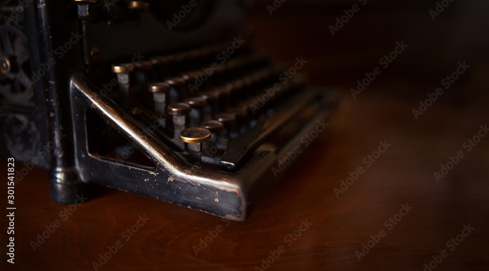Aufkleber selective focus on the keyboard key on an old black rustic typewriter on a desk in the office. the t