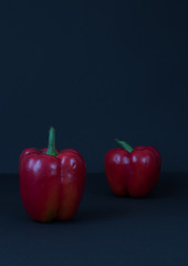 red bell Bulgarian peppers on black background