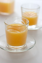 Two glasses of refreshing orange juice on a white table