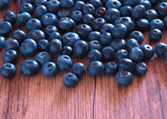 Blueberry berry on a wooden table. Summer and vitamins