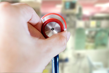 Fototapeta premium Closeup and crop Hands pick small stethoscope doctor on blurred background.