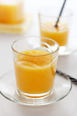 Two glasses of refreshing orange juice on a white table
