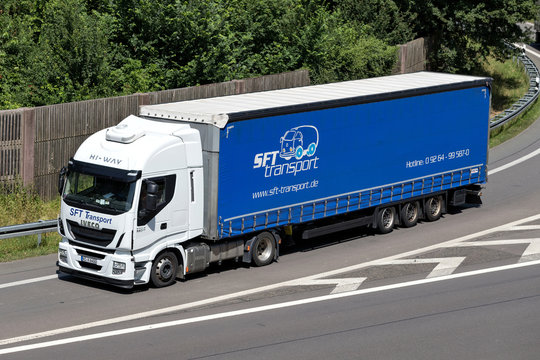 WIEHL, GERMANY - JUNE 25, 2019: SFT Transport Ivceo Stralis truck with curtainside trailer on motorway.