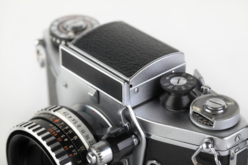The old German 35 mm SLR film camera with lens 50 mm lens on a white background. Shaft Viewfinder...