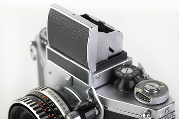 The old German 35 mm SLR film camera with lens 50 mm lens on a white background. Shaft Viewfinder...