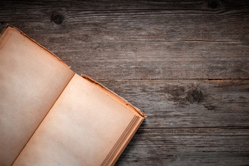 Vintage book, open, on old wooden table, with clipping path. Open Book blank on old wooden...