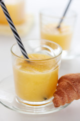 Two glasses of refreshing orange juice on a white table