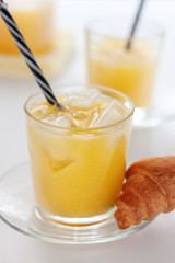 Two glasses of refreshing orange juice on a white table