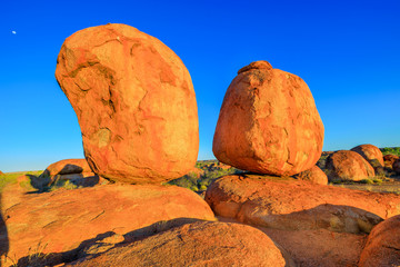Popular and iconic Devils Marbles: Eggs of mythical Rainbow Serpent at sunset. Karlu Karlu - Devils Marbles is one of Australia's most famous natural wonders in Northern Territory, Outback Red Centre.
