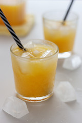 Two glasses of refreshing orange juice on a white table