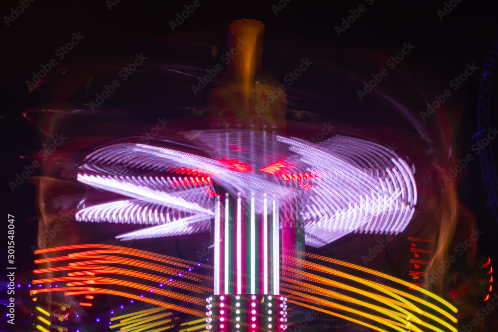 Canvas Prints A blurry colorful carousel in motion at the amusement park, night illumination. Long exposure.