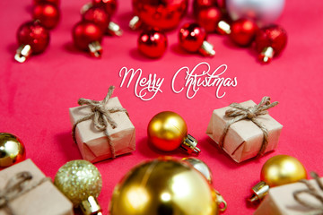 Merry Christmas and happy holidays xmas gifts. Baubles, presents, candy with christmas ornaments. Top view. Christmas family traditions on red background