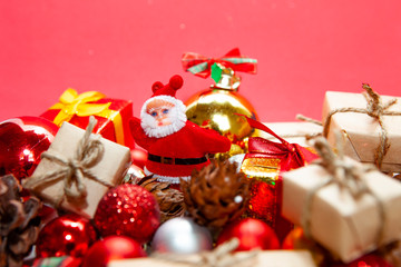 Merry Christmas and happy holidays xmas gifts. Baubles, presents, candy with christmas ornaments. Top view. Christmas family traditions on red background