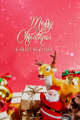 Merry Christmas and happy holidays xmas gifts. Baubles, presents, candy with christmas ornaments. Top view. Christmas family traditions on red background