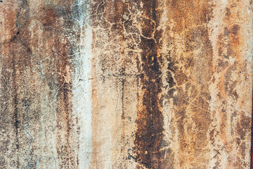 Fragments of old concrete wall, peeling paint cement surface. Grunge texture. Rusty, spotted concrete background