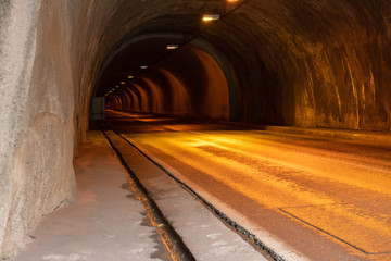 Fototapeta na wymiar old tunnel in orange light for cars, long perspective