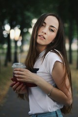 Young pretty girl walking down the street