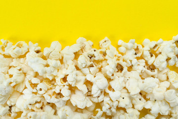 Popcorn on a yellow background. Copy space.