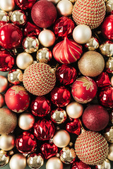 Closeup of red and gold Christmas baubles / balls. Flat lay, top view New Year / Christmas pattern.