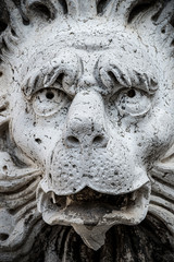 Funny ancient decoration element of a scary lion head at roof of Basilica San Marco and Doge Palace in Venice, Italy, summer time, closeup,, details
