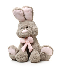 Old rabbit toy isolated on wood background