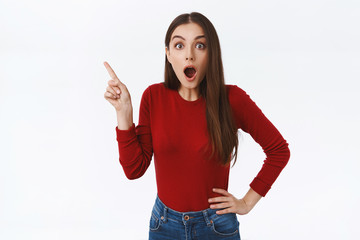 Shocked, amused attractive girl dropping jaw as see amazing promo, stunning chance studying abroad,...