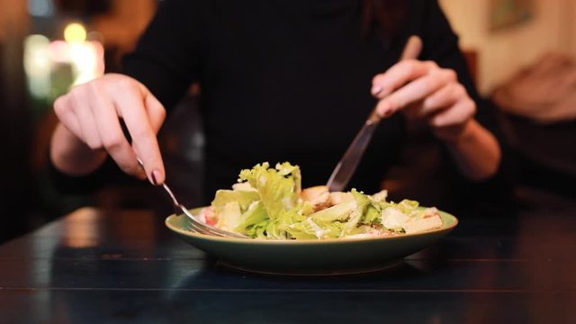 Macro video of woman mixing and eating Caesar salad closeup
