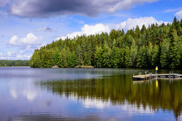 Picturesque lake with forest on the shore. Typical nature of Finland.