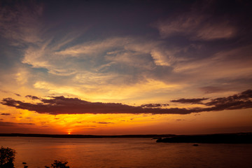spectacular sun fall. Scene during sunset. Golden and orange colors and nuances flood the scene. Dramatic sunset.