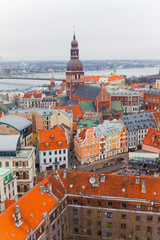 Obraz premium Panorama view from Riga cathedral on old town of Riga, Latvia. Beautiful aerial view of the Riga city centre. View of the roofs of the old town from above. Winter season in Riga, Latvia.