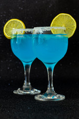 Blue drinks close up, selective focus, black background