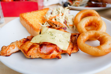Grilled Chicken steak with salad and onion rings
