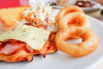 Grilled Chicken steak with salad and onion rings