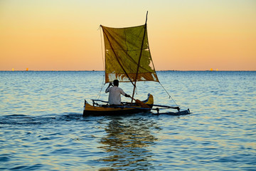 Anakao/Madagascar-06/12/2019 Malagasy fisherman in a traditional catamaran, sailing on the ocean...