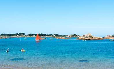kayakers paddling along the picturesque red granite coast of northern Birttany