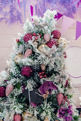 A fragment of Christmas-design Christmas tree ornaments and holiday rooms. Festive decoration of the room