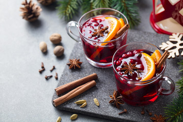 Mulled red wine with spices. Christmas decoration. Grey stone background. Copy space.